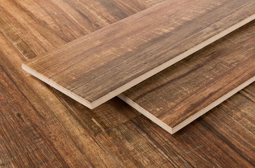 Stacked brown wood-look tile planks showing edges and grain
