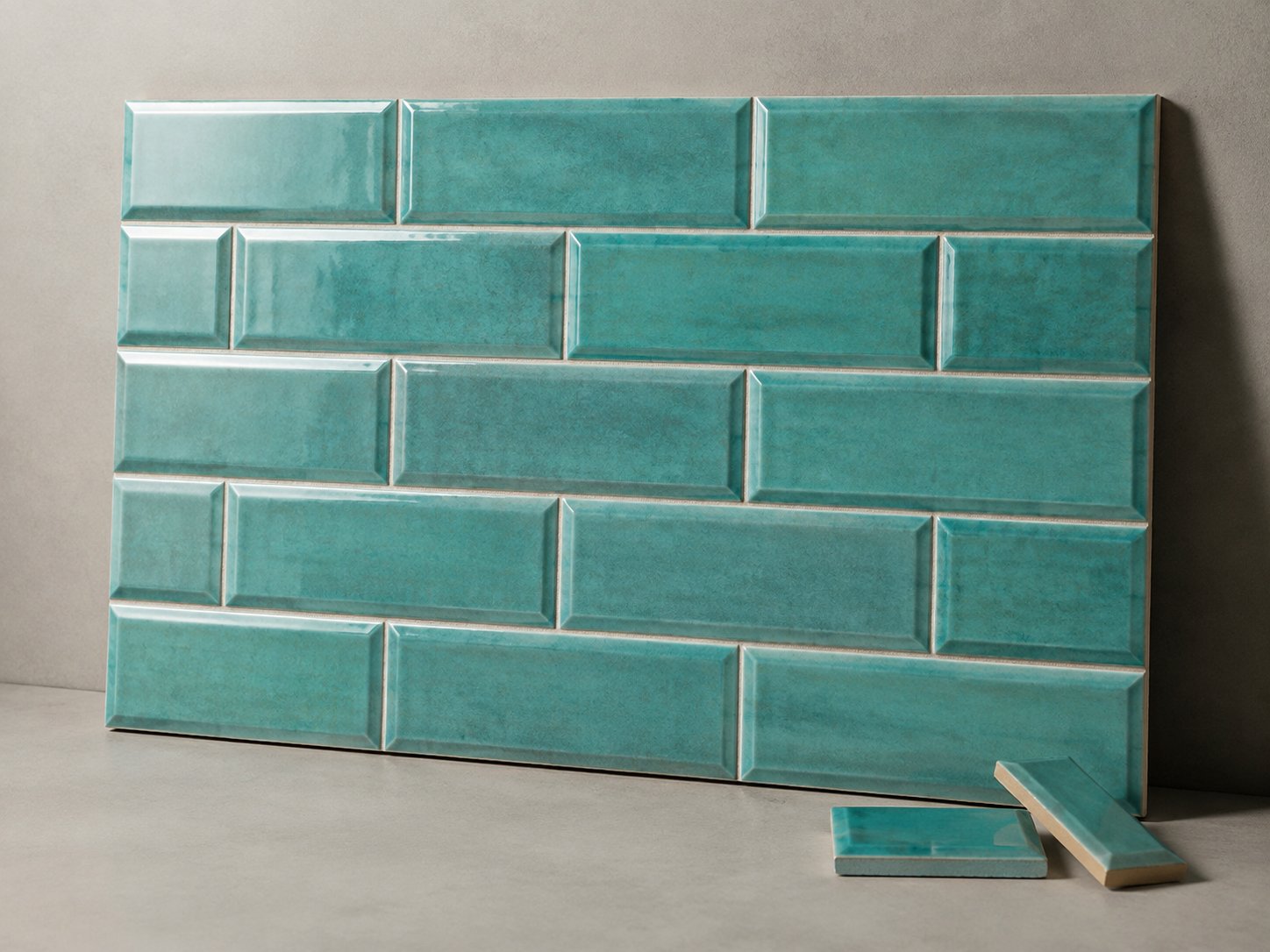 Turquoise bevelled subway tile samples showing glazed face and edge profile